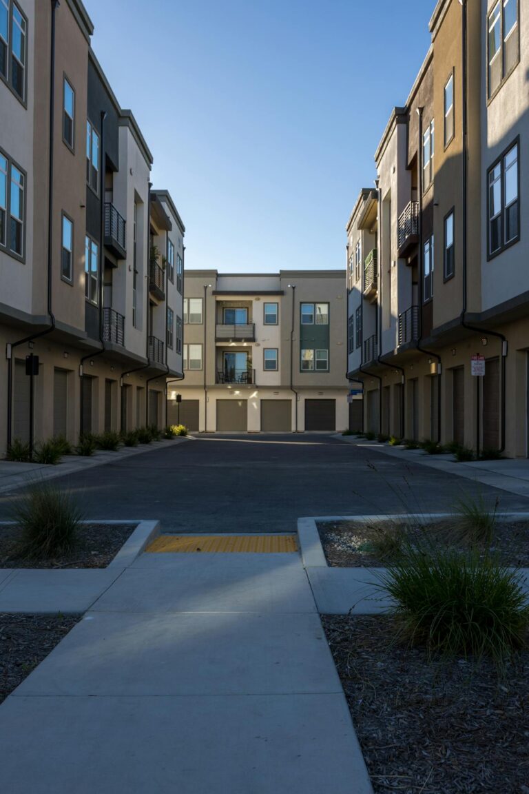 A view of modern urban apartment buildings under clear blue skies.